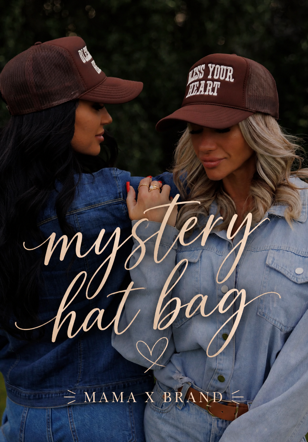 Two women in denim jackets and brown trucker hats stand close together outdoors. One hat features the phrase “Bless Your Heart.” Script text over the image reads “Mama X - Mystery hat bag,” with “Mama X™ Brand” at the bottom.