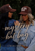 Two women in denim jackets and brown trucker hats stand close together outdoors. One hat features the phrase “Bless Your Heart.” Script text over the image reads “Mama X - Mystery hat bag,” with “Mama X™ Brand” at the bottom.