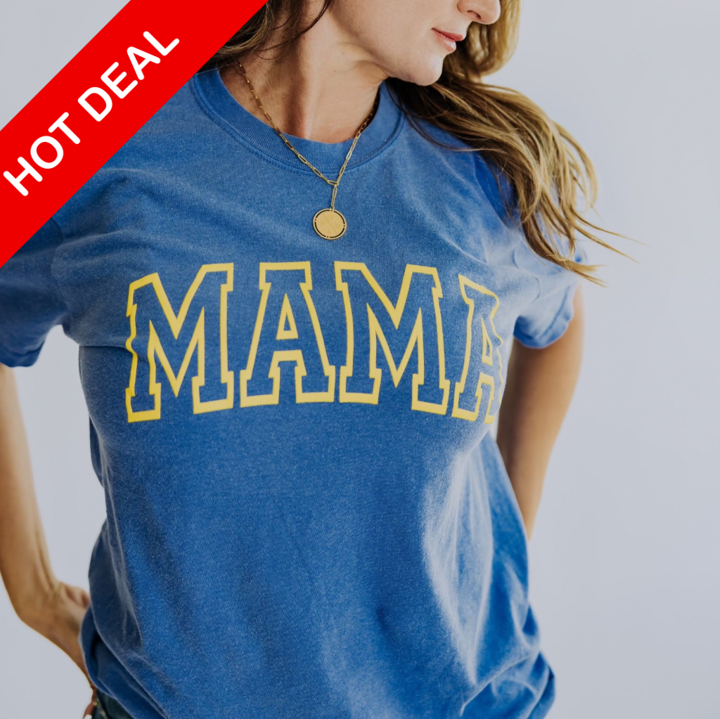 A woman clad in a Mama X™ Brand's oversized blue Mama T-Shirt, featuring 