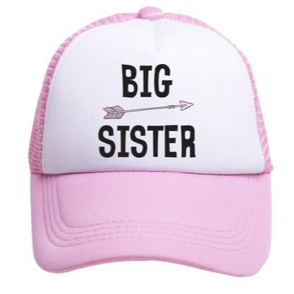 The Big Sister Trucker Hat by Mama X™ Brand, featuring a pink and white color scheme with a mesh back, is perfect for gender reveals. The front of the cap showcases the words 