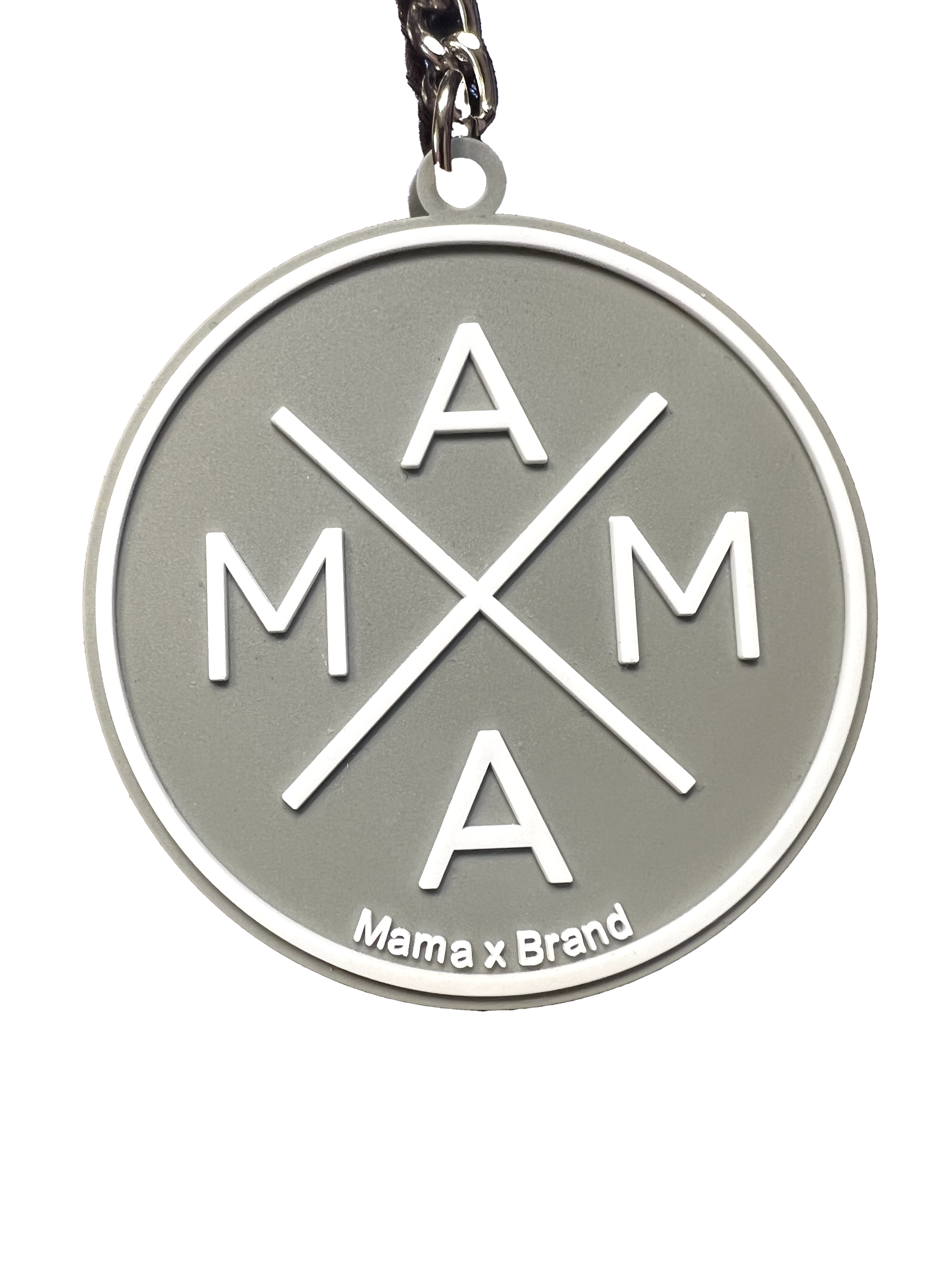 The Mama X™ Keychain is a round, silver keychain that showcases the text 