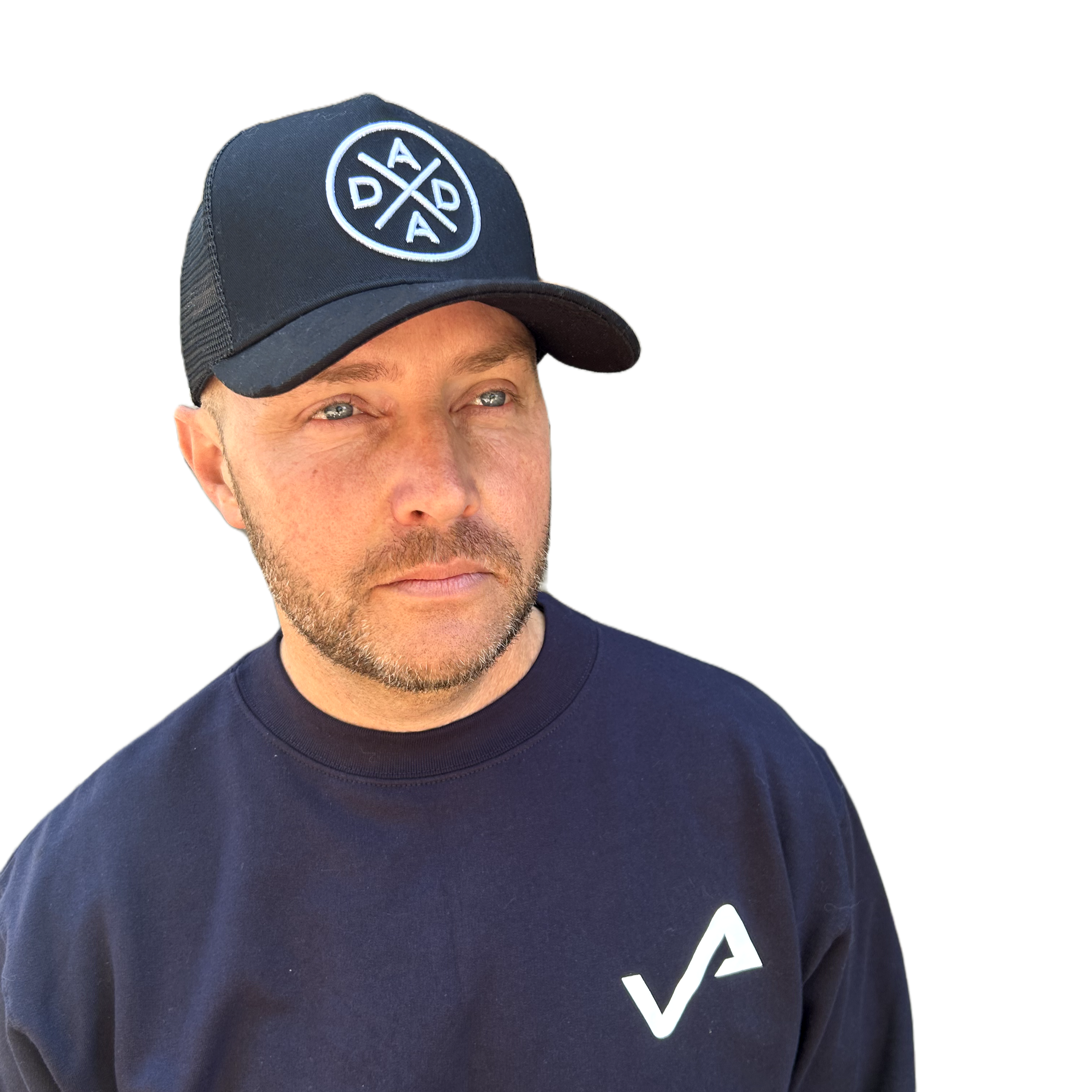 A man with light skin, short hair, and a beard is wearing a Mama X™ Brand Dada X™ Premium Trucker Hat Curved Brim with a 3D embroidered "DADA X" logo and an adjustable sizing strap. His navy sweatshirt features a small "VA" logo. He has a neutral expression and is looking slightly off to the side against a white background.