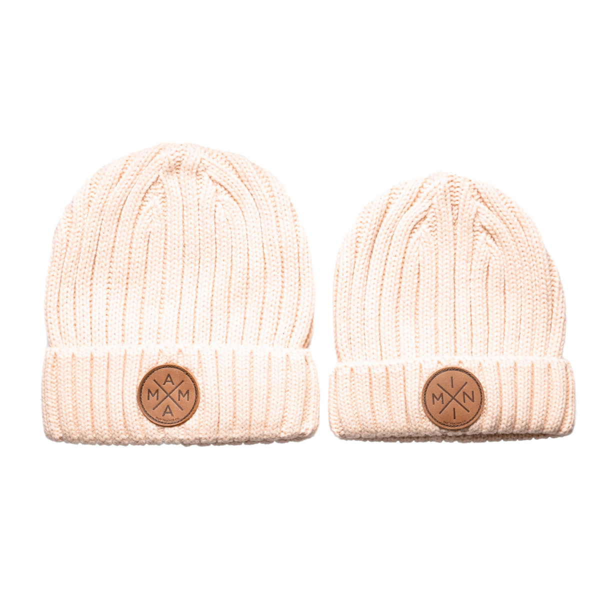 Two essential Fall and Winter knitted off-white beanies from Mama X™ Brand, featuring ribbed textures and folded cuffs. The larger 