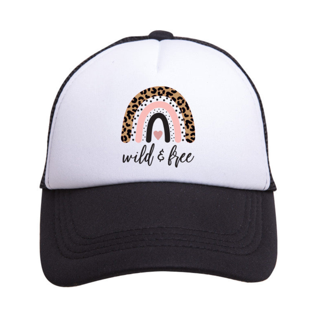 Introducing the Wild & Free Trucker Hat by Mama X™ Brand: This stylish hat features a striking black and white animal print, adorned with a cute rainbow design. The rainbow boasts three unique arches: leopard print, pink with white dots, and solid grey. Below the rainbow, 