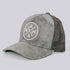 The Mama X™ Trucker Hat - Gray Suede by Mama X™ Brand features a gray suede-like front and a mesh back. The front panel displays a circular emblem with the text "MAMA" in a cross pattern. This stylish 5-panel cap includes an adjustable strap at the back for your convenience.